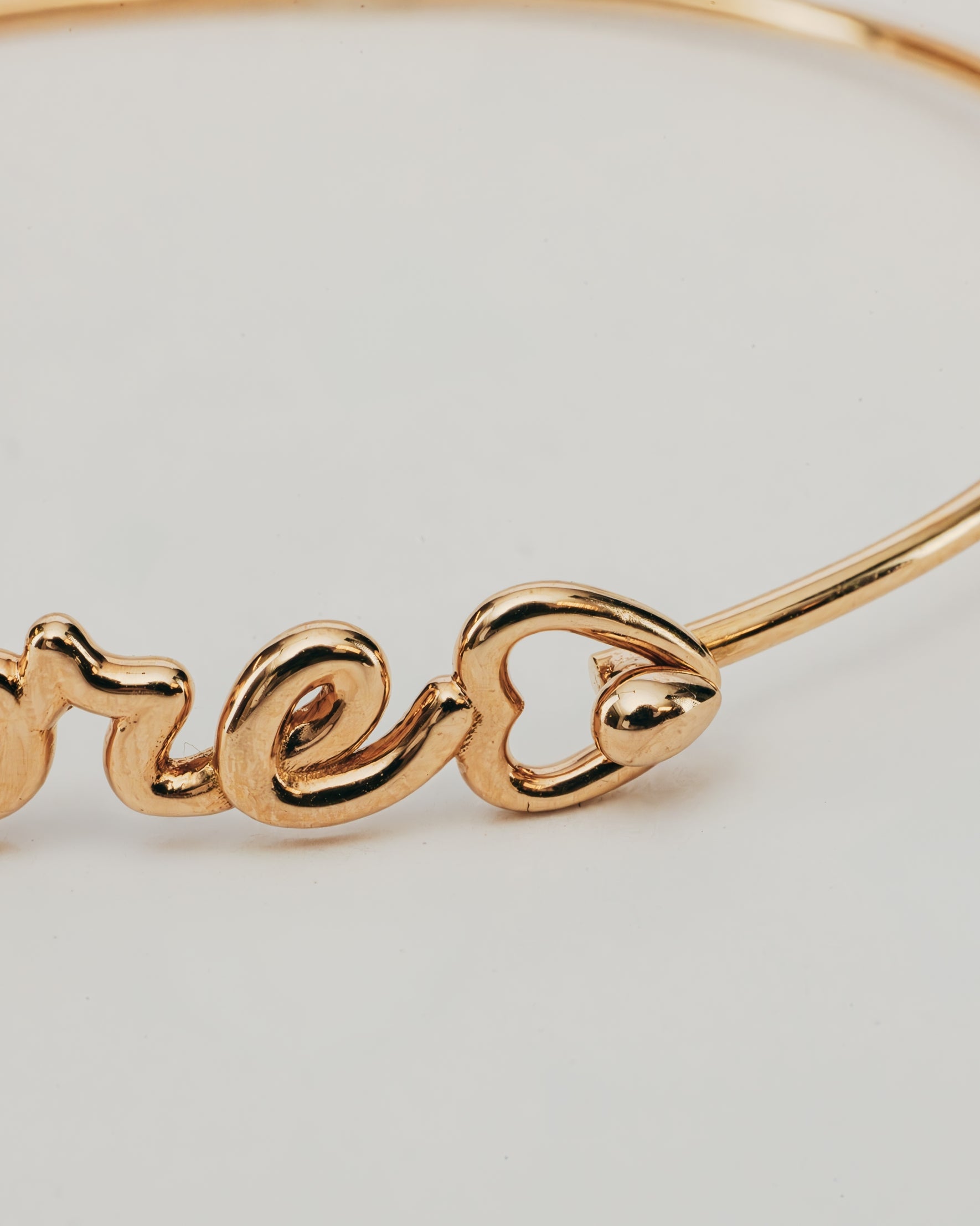 Bracciale Rigido Dorato Amore con Punto Luce
