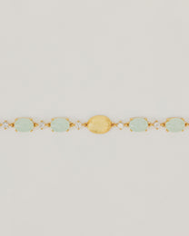 Bracciale Dorato con Pietre Cabochon e Dettagli Luminosi Verde