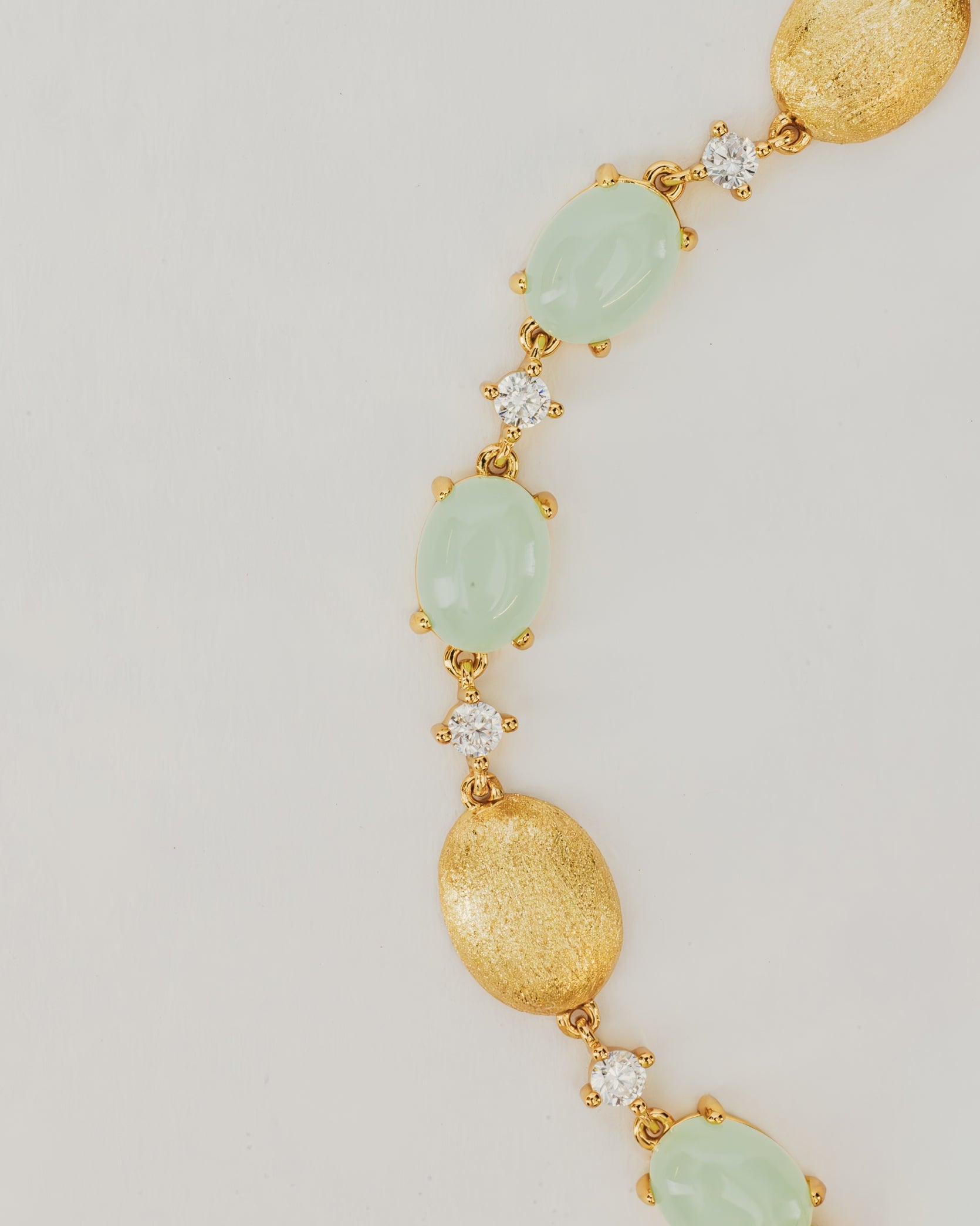 Bracciale Dorato con Pietre Cabochon e Dettagli Luminosi Verde